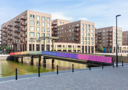 Rainbow colours painted on a bridge crossing the water