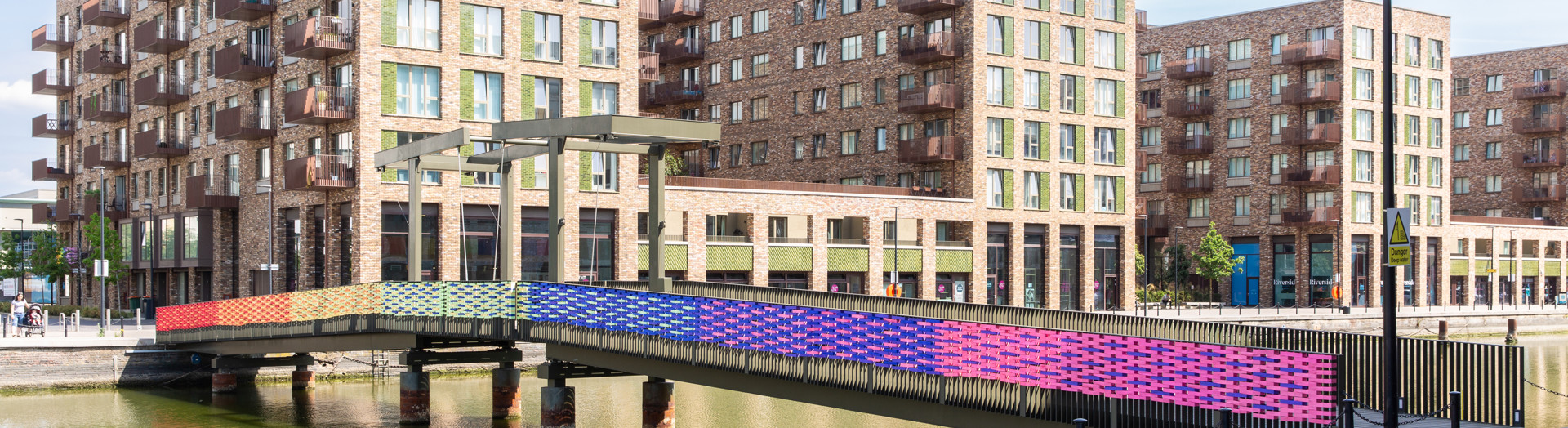 Rainbow colours painted on a bridge crossing the water