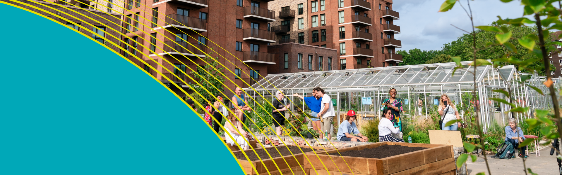 A group of people hanging out in a community with a green house and flats visible in the background.
