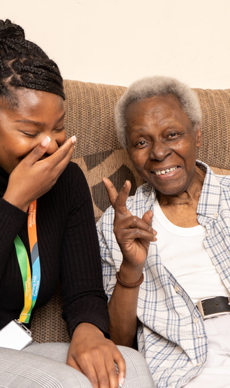 A resident in their home seated with a housing officer. 
