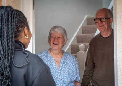Older couple meeting their housing officer at their front door
